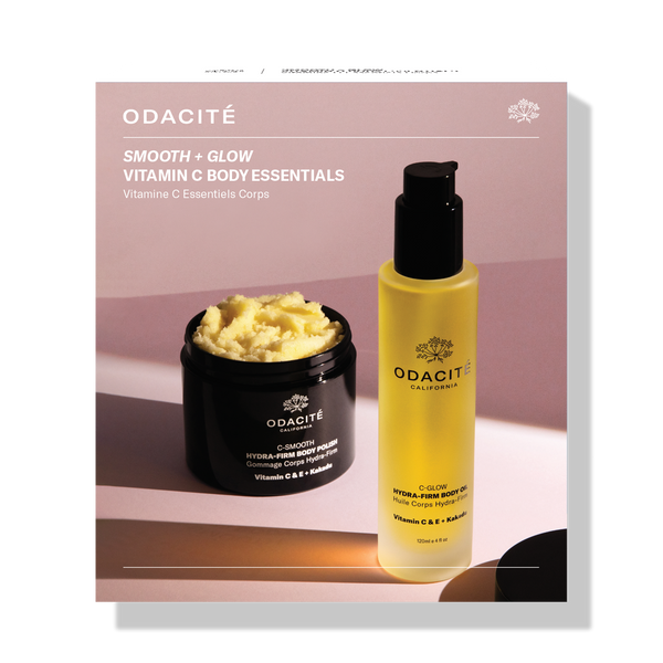 Odacité Smooth & Glow • Vitamin C Body Essentials set with two bottles and a jar in white and gold packaging on a neutral background.