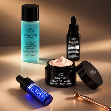 The Odacité Fall Reset Box contains four skincare products in assorted bottles and jars arranged together.