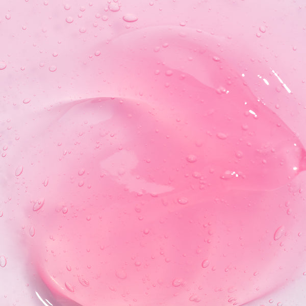 Odacite Bioactive Rose Gommage enzyme mask in a clear jar, showing pink gel texture and label with product details.