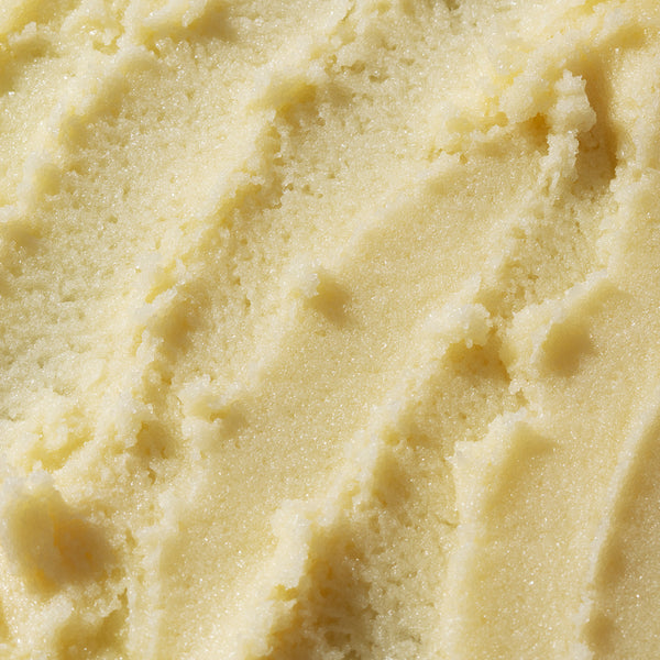 Smooth & Glow • Vitamin C Body Essentials by Odacité shown close up, pale yellow cream with a smooth, polished texture.