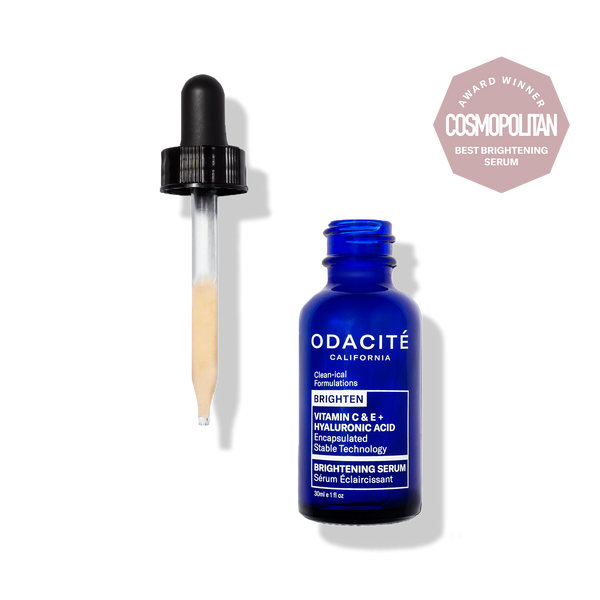Odacité Brightening Serum with Vitamin C & E and Hyaluronic Acid in a dropper bottle, next to Cosmopolitan Award badge.