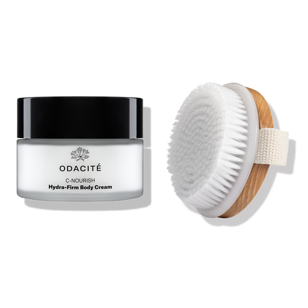 Odacité’s The Body Ritual next to a wooden-handled dry brush with white bristles.