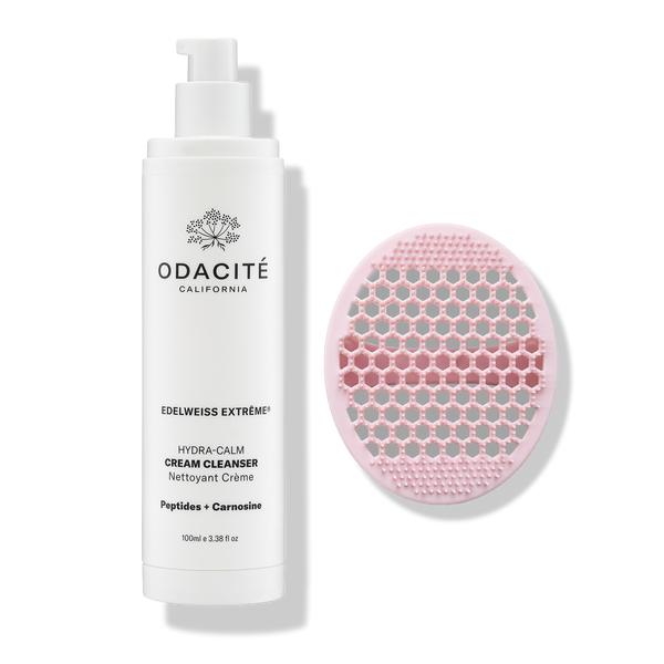 Odacité Daily Calm Cleansing Duo with a tube of cream cleanser and a pink silicone brush on a white background.