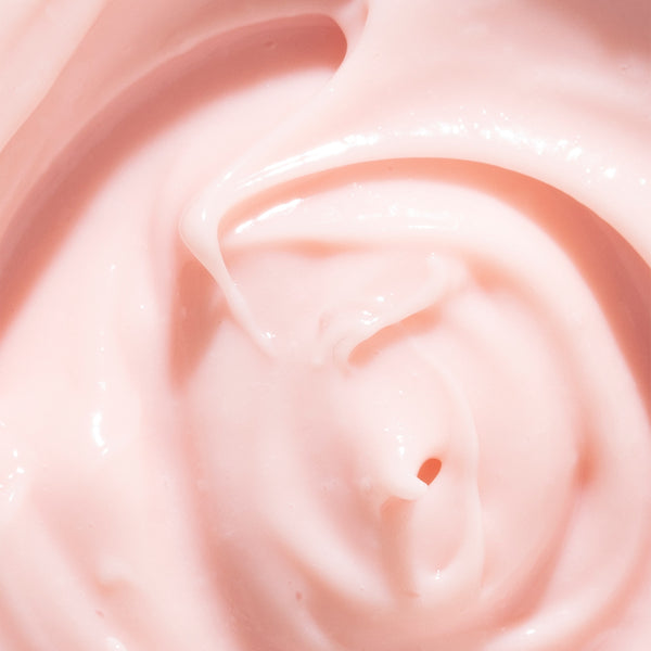 Odacite Crème de la Nuit night cream in light pink, creamy texture, shown in an open jar with visible product inside.