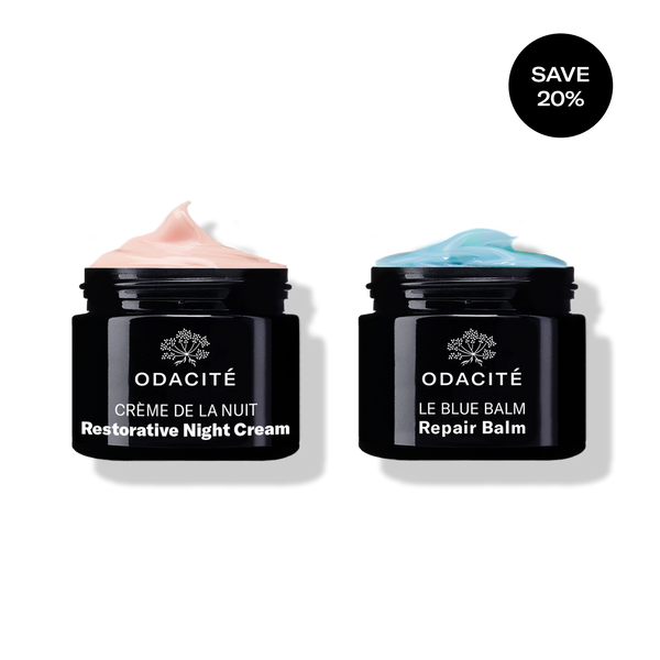 Odacité Deep Moisture Duo with two black jars: Restorative Night Cream (pink label) and Repair Balm (blue label).