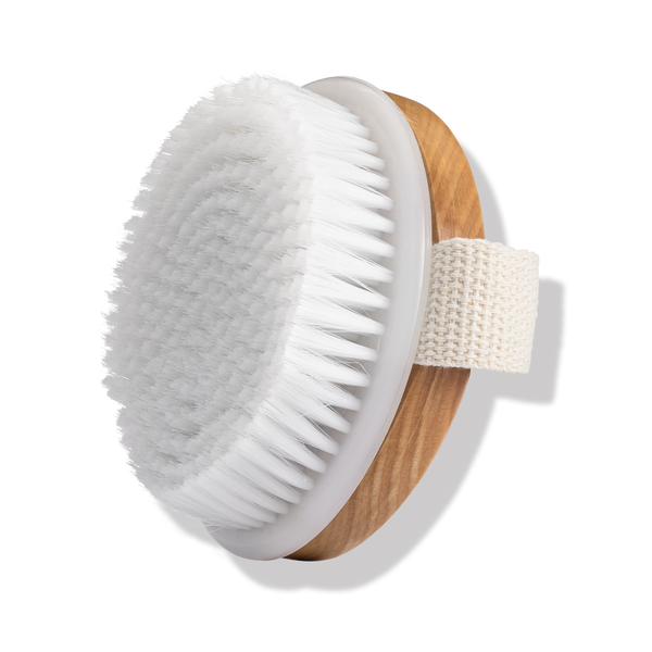Odacité Odacite Dry Spa Brush with white round vegan bristles, light wooden base, and attached strap for hand grip.