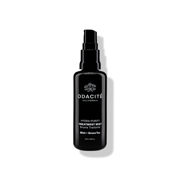 Odacité Hydra-Purify Treatment Mist sample spray bottle casting a soft shadow on a plain light background.
