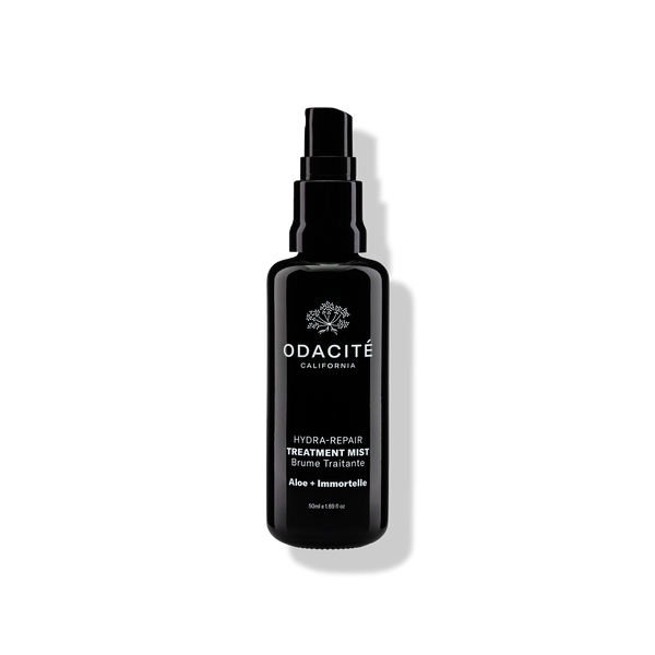 Black Odacite Hydra-Repair • Aloe + Immortelle Treatment Mist bottle with a spray nozzle and white label text.