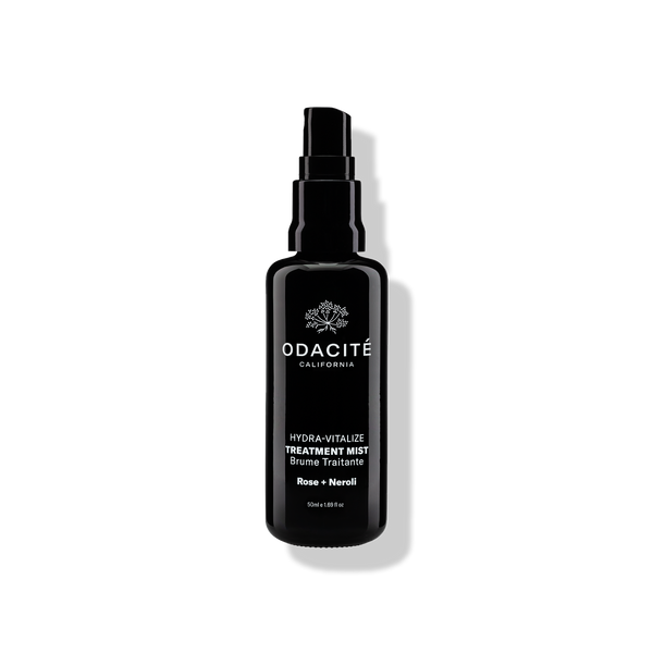 Odacite Hydra-Vitalize • Rose + Neroli Treatment Mist in a black spray bottle on a white background with visible shadow.