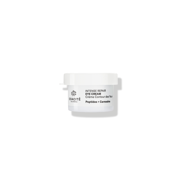 White jar of Odacité Intense Repair Eye Cream Refill with Edelweiss Extrême, Peptides, and Carnosine on a plain background.