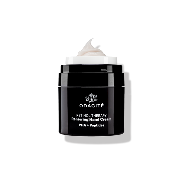 Odacité Retinol Therapy Renewing Hand Cream with PHA + Peptides in a matte black jar with white text.