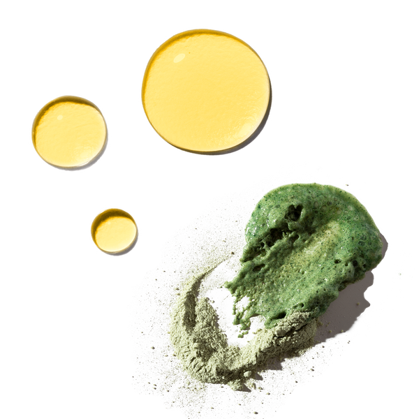 Three golden drops of Safflower Oil cleanser and green matcha exfoliating paste from the Odacité Uneven Skin Double Cleansing Set.