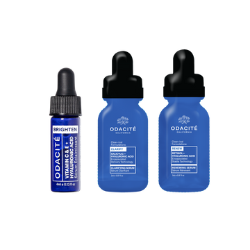 Three blue bottles of Odacité March Deluxe Sample serums labeled Brighten, Clarifying, and Renew.