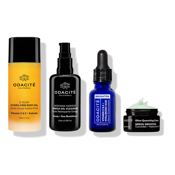 Odacité's Travel Fundamentals—body oil, cleanser, serum, and green moisturizer—in travel bottles on a white background.