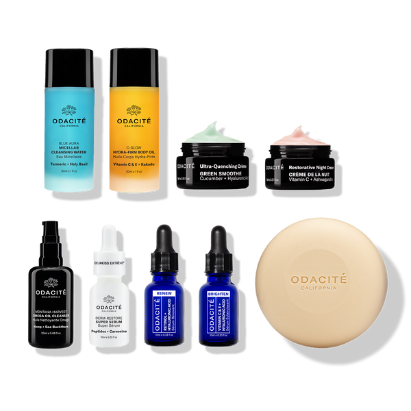 Odacité Luxe Experience set with travel-size gels, creams, serums, and a round soap on a white background.