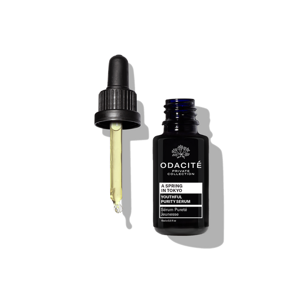 A dark blue Odacite Youthful Purity Serum • A Spring in Tokyo bottle on a plain white background.