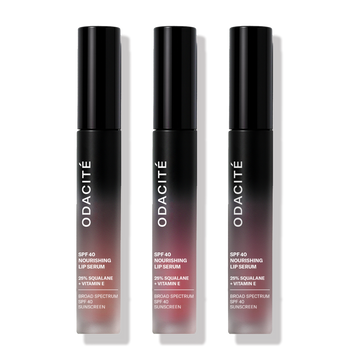 Three black gradient Odacité LIP SERUM SPF DUO tubes stand upright against a light background.