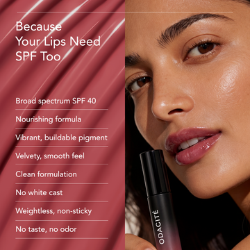 Woman with shiny lips holds Odacité SPF 40 Nourishing Lip Serum in a small clear tube with white cap.