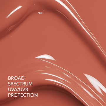 Peach-colored Odacité SPF 40 Nourishing Lip Serum with a glossy finish; 