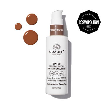 Odacité SPF 50 tinted sunscreen bottle with visible brown liquid swatches and a Cosmopolitan Clean Beauty Awards 2023 badge.