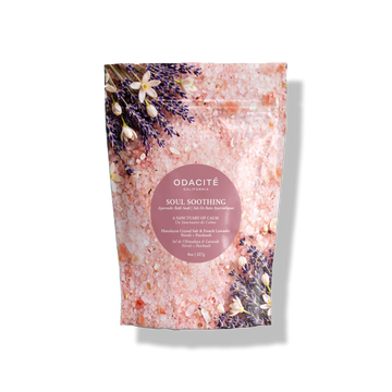 Soul Soothing Ayurvedic bath soak with Himalayan crystal salt, French lavender, neroli, and patchouli, decorated with lavender and flowers.
