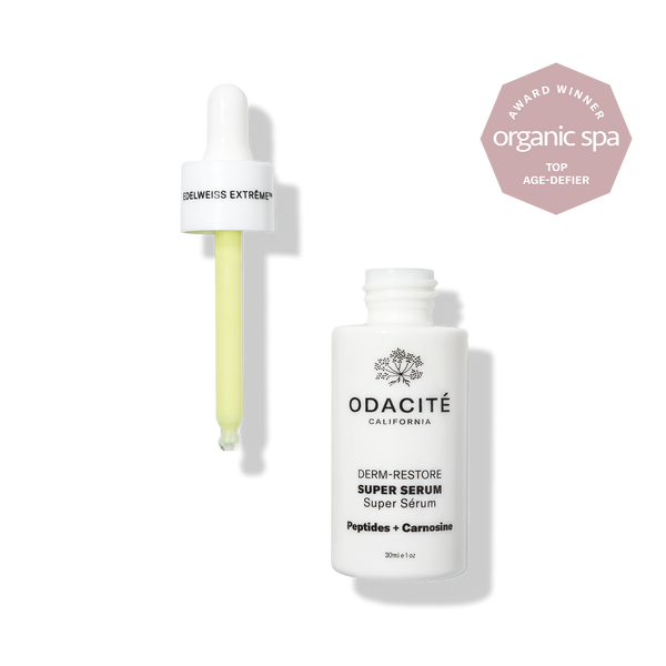 Dropper with yellow serum and open Odacité Edelweiss Extrême® Skin Barrier Set on display, showing product packaging.