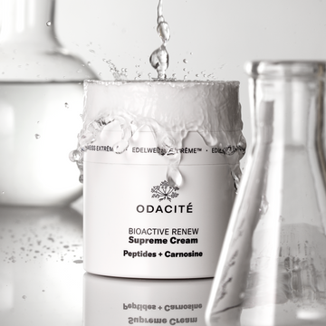 Odacite Bioactive Renew Supreme Cream jar with droplet effect on a white background