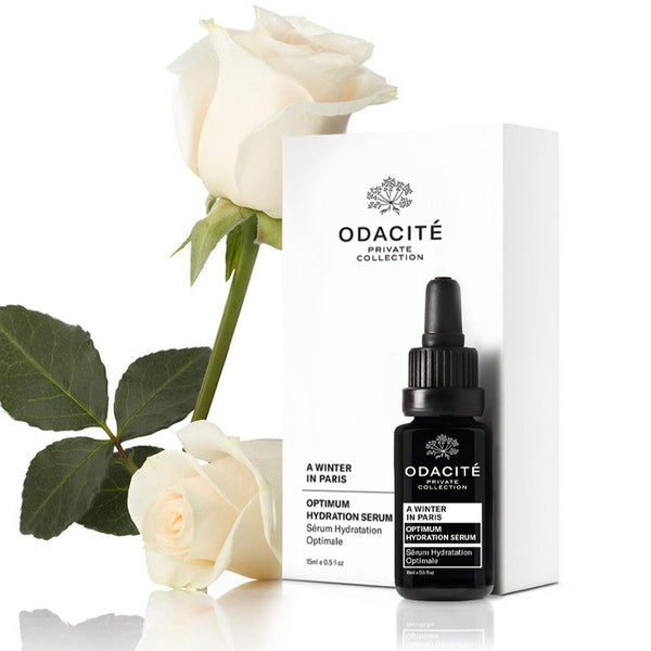 Odacite Optimum Hydration • A Winter in Paris serum bottle and box with white roses, highlighting camellia seed oil.