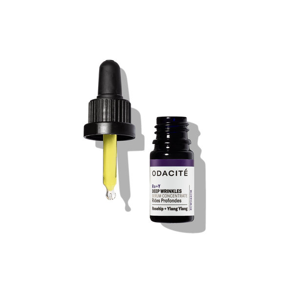 Odacite Ro+Y Deep Wrinkles Serum Concentrate in a small bottle with dropper, yellow liquid inside, on a white background.