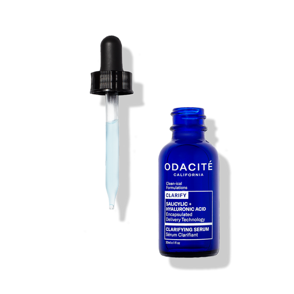 Odacité Clarifying Serum Salicylic + Hyaluronic Acid with glass dropper and light blue liquid on a white background.