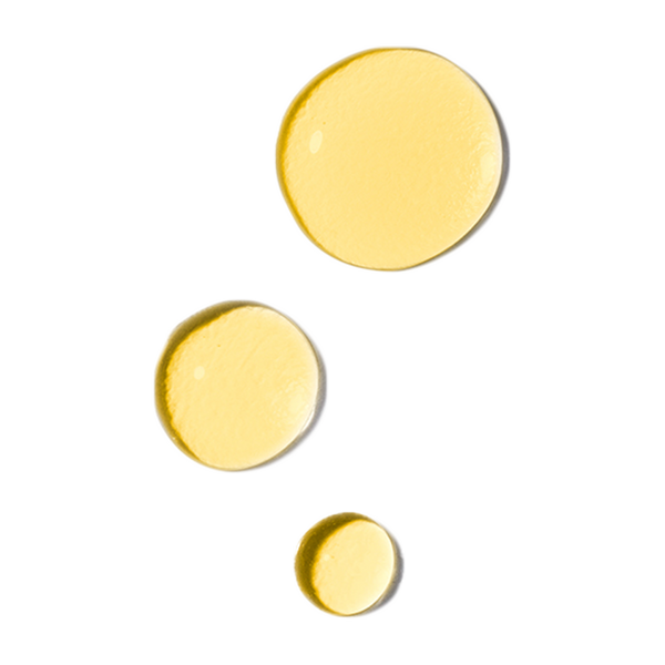 Three yellow drops of Odacite All-Embracing Watermelon + Hibiscus Facial Oil arranged diagonally on a white background.