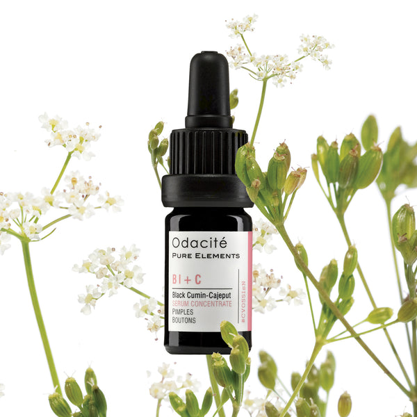 Odacite Clear + Decongest Pimple-Prone Duo dropper bottle placed among white flowers and green stems on a white surface.