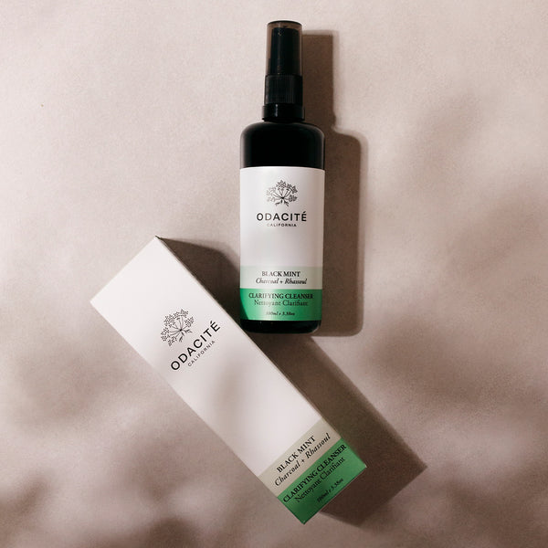 Odacité Double Cleansing Set with Omega Oil Cleanser and Clarifying Cleanser in clear pump bottles, placed side by side.