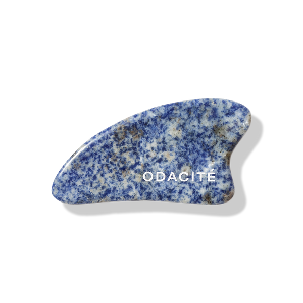 Odacite Crystal Contour Blue Sodalite Gua Sha tool, dark blue stone with curved edges for facial massage.