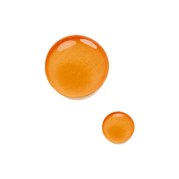 Two orange, glossy drops of Odacite Firming Buriti + Lime Bu+L Serum Concentrate on a plain white background.