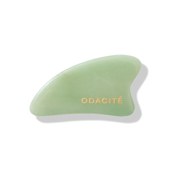 Odacite Crystal Contour Green Aventurine Gua Sha, green stone tool with gold lettering, shown on a white background.