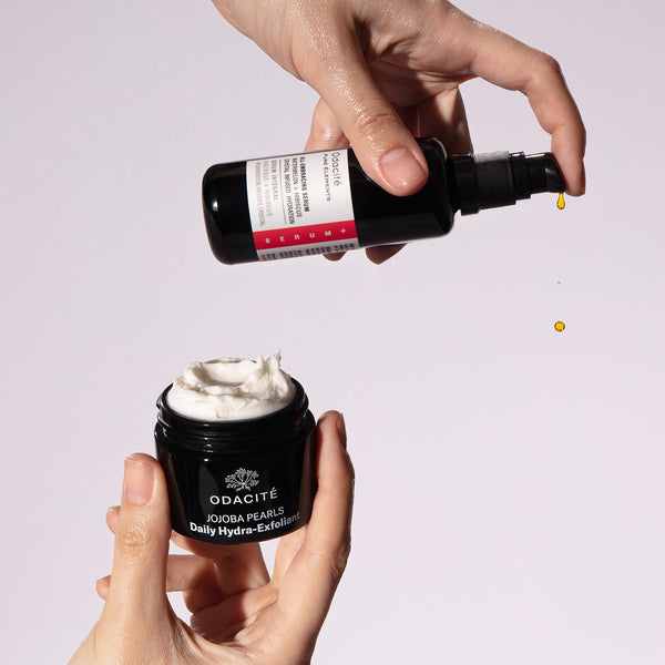 A hand pours serum into Odacité Hydra-Foliate • Cashmere Skin Duo packaging. Both products are visible.