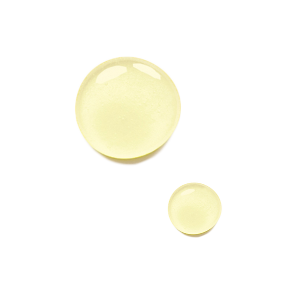 Two yellow drops of Odacite Hydra-Plump Ma+N Serum Concentrate on a white background, one larger than the other.